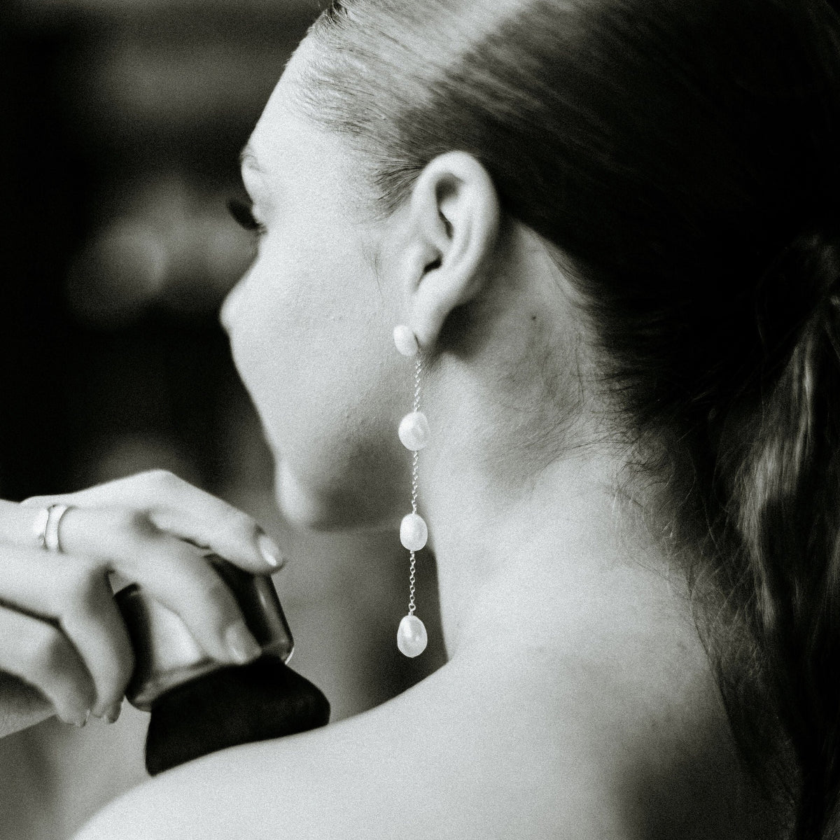 long pearl drop earrings on model in black and white