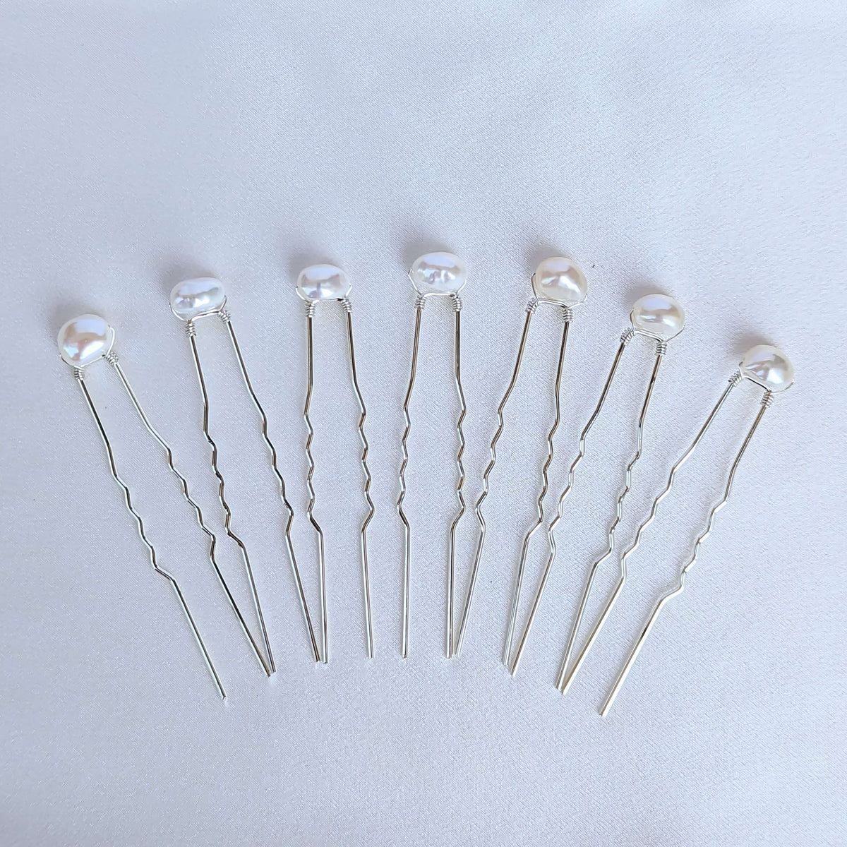 set of 7 medium sized real freshwater pearls on silver coloured hair pins