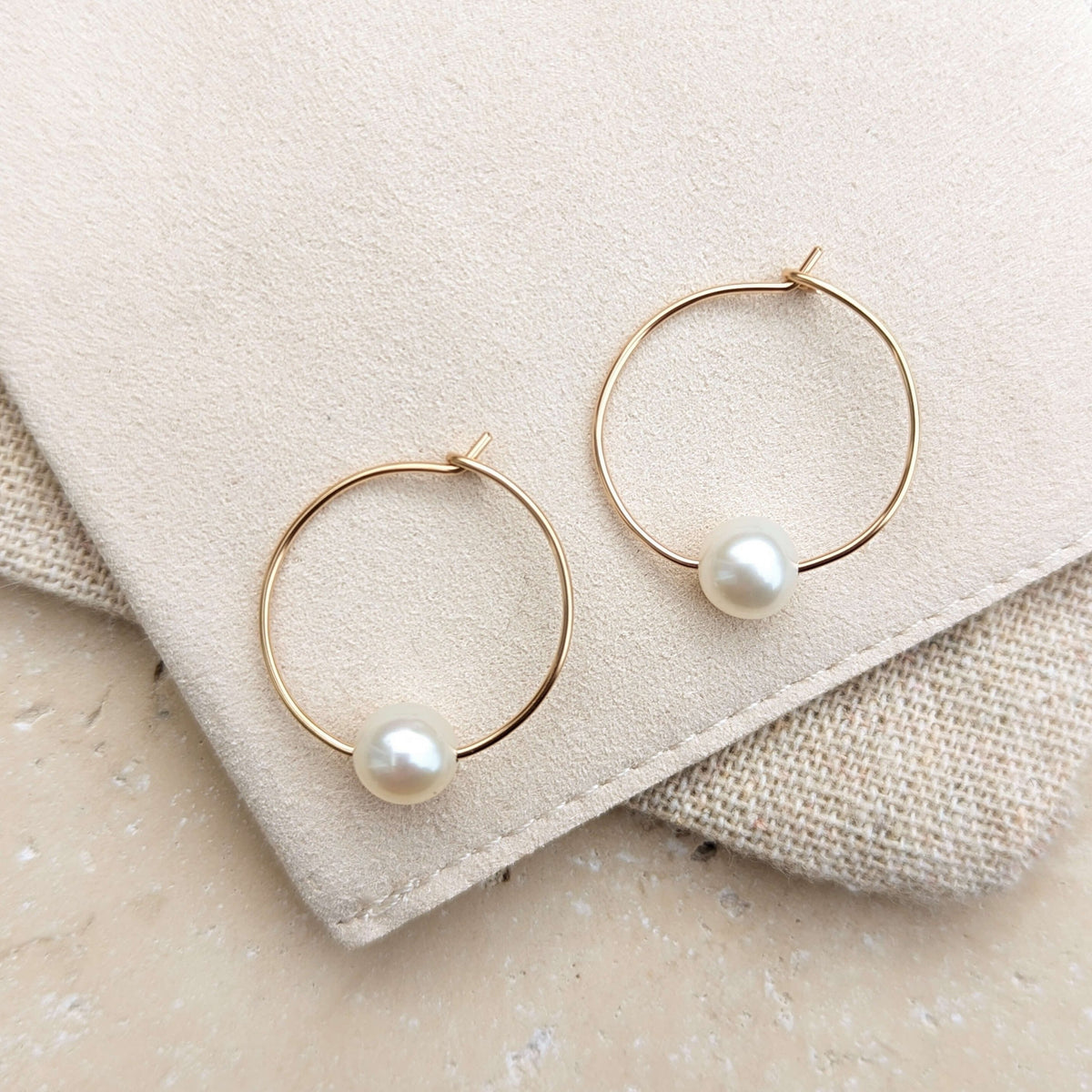 wire hoop round pearl earrings in gold filled flatlay