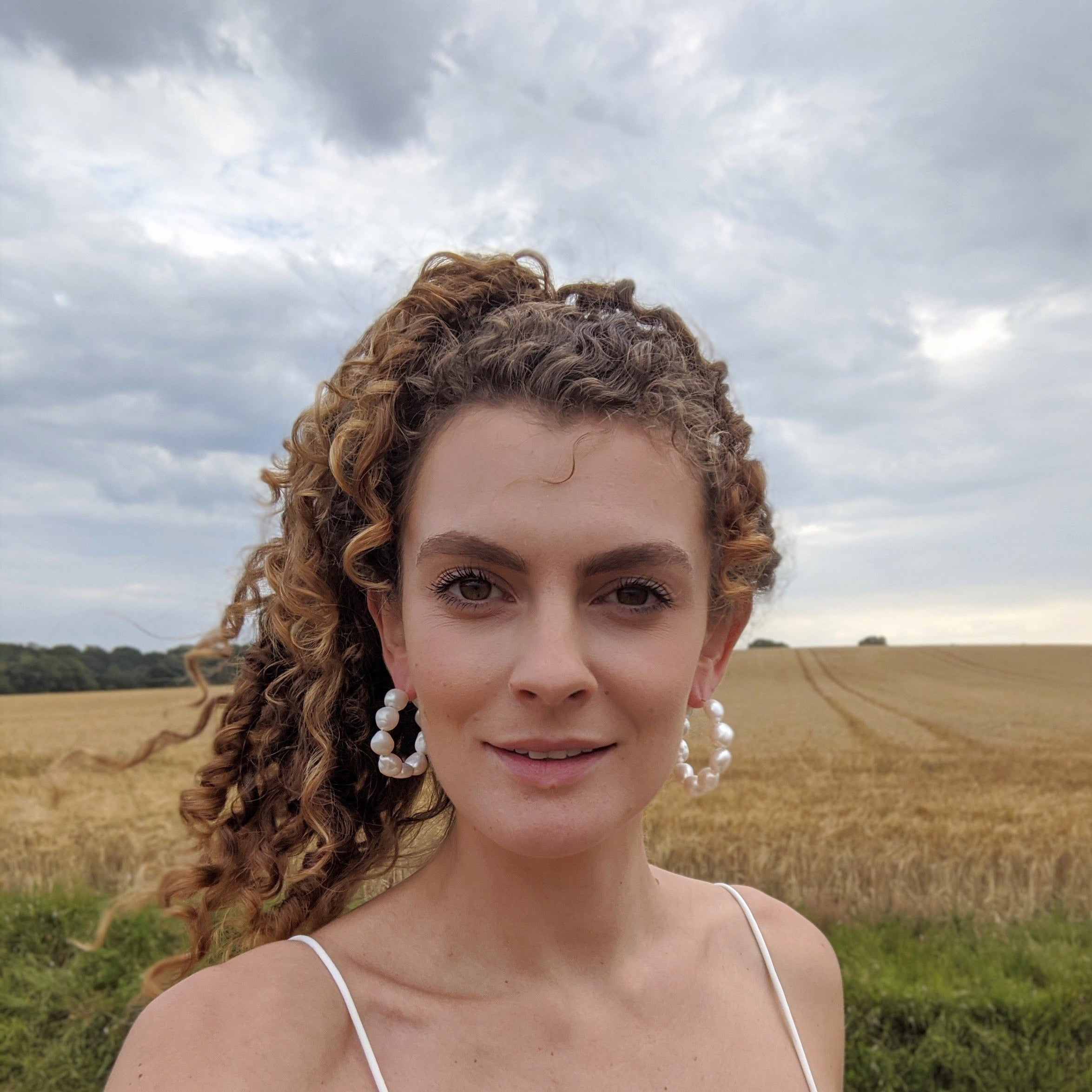 girl wearing large freshwater baroque earrings