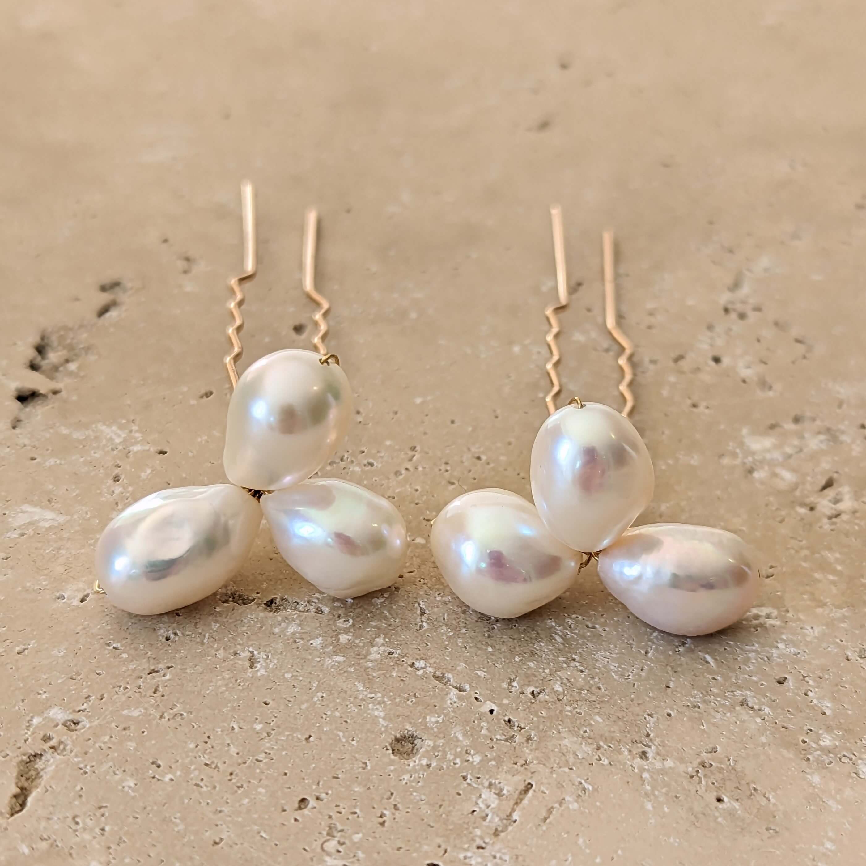 two pearl hair pins in gold