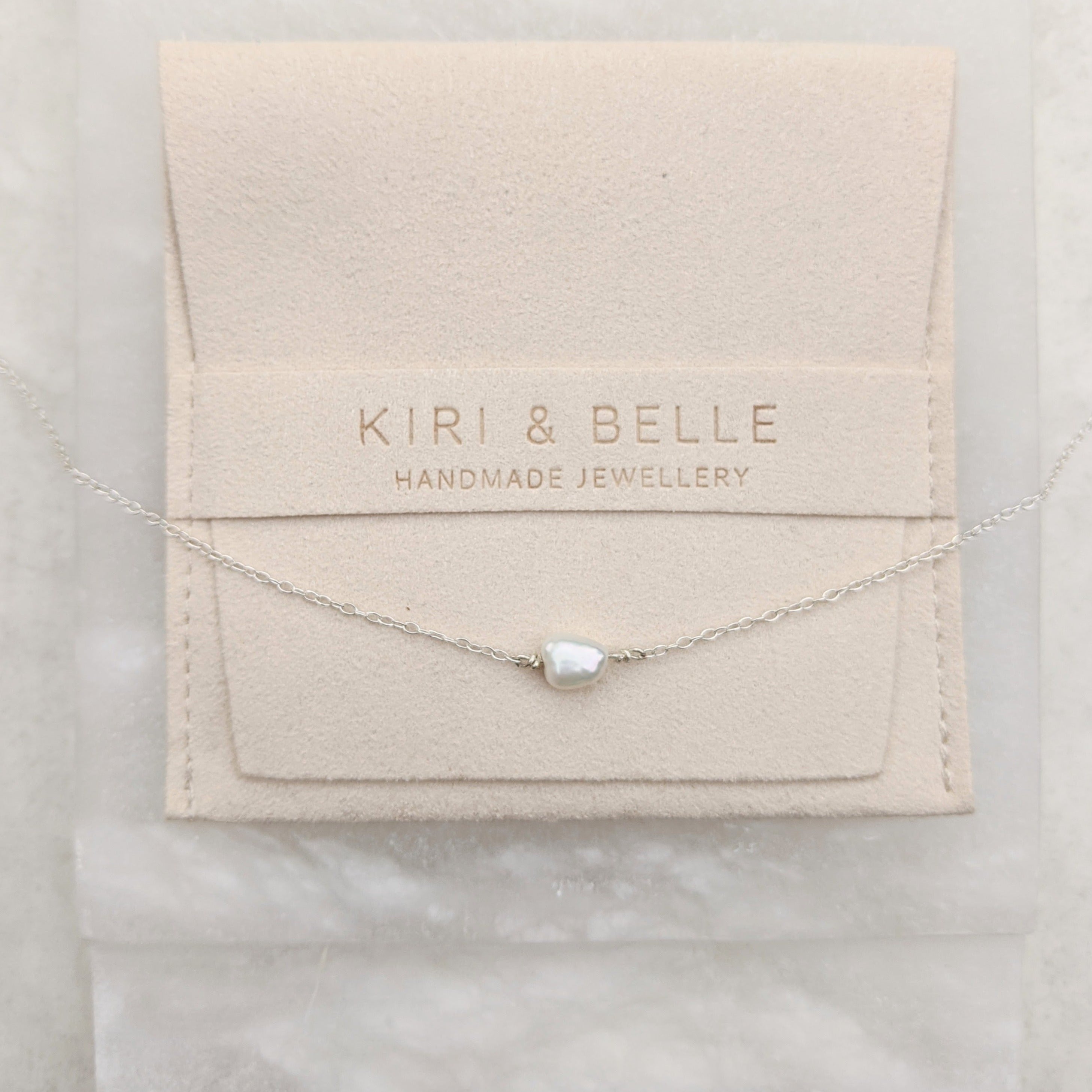 Single small pearl sideways on sterling silver necklace chain